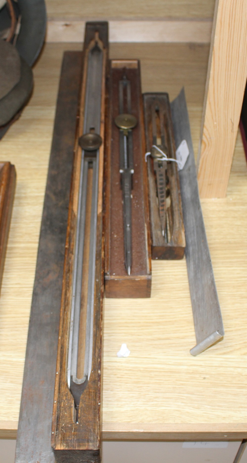 Three wooden cased technical draughtsman tools, stamped for the owner FJ Pearl, largest 77cm